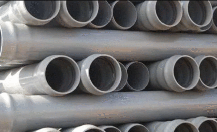 Grey waste pipes arranged in a stack.