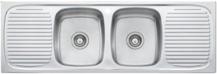 A shiny stainless steel kitchen sink with two bowls and a draining board on both the left and right sides.