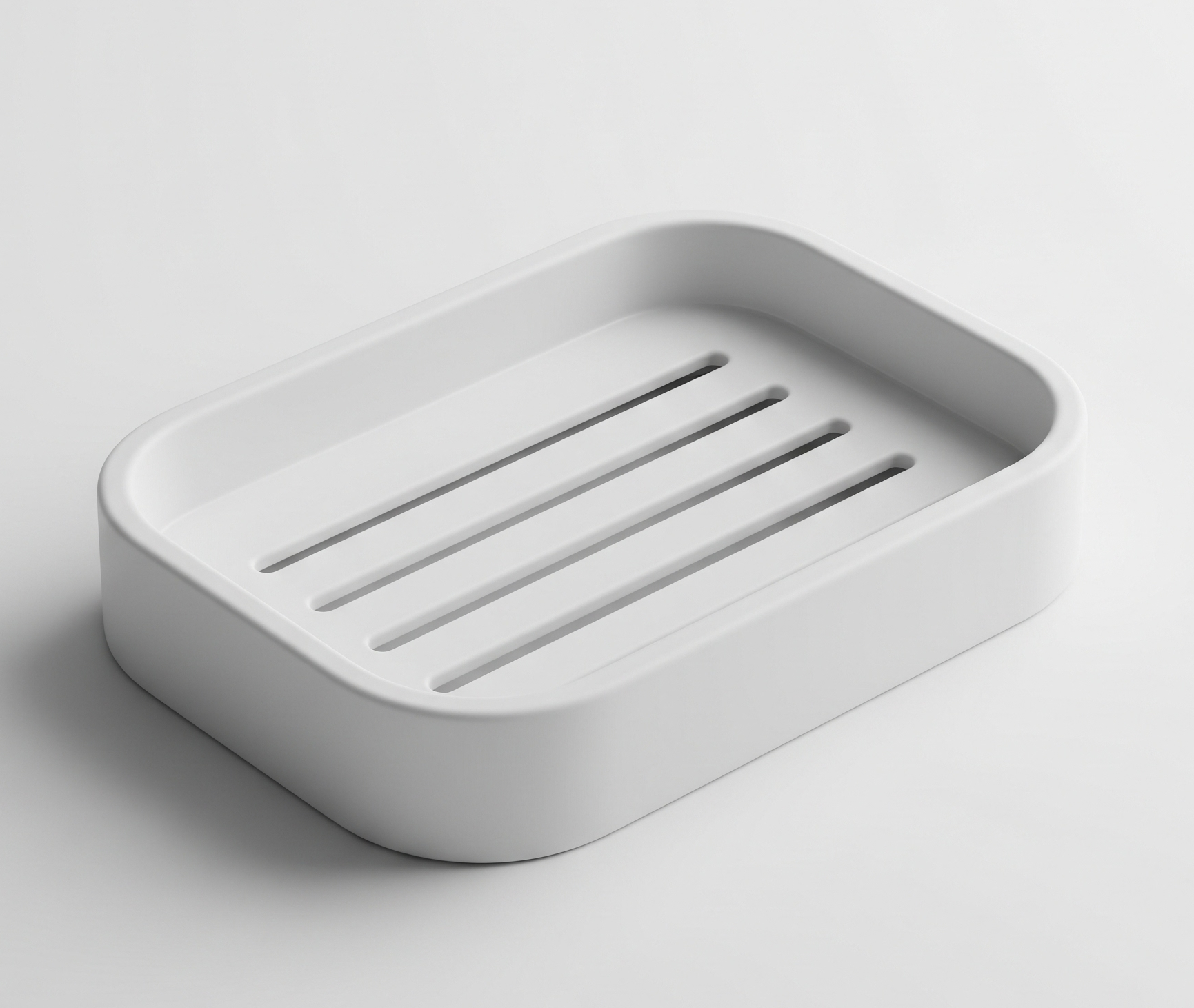 A close-up product photo of a simple white plastic soap dish with drainage slots and rounded corners, on a white background.