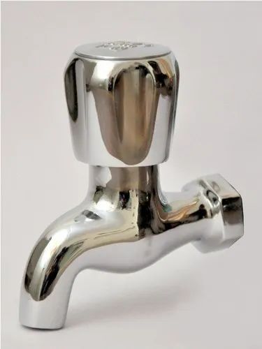 A modern, polished chrome short neck wall tap. The tap has a polished, reflective finish, a curved spout, and a classic fluted knob handle on top.