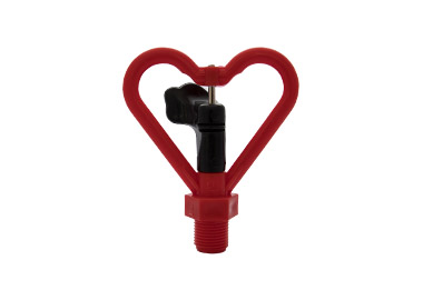 A top-down view of a small, red and black sprinkler head. The red plastic frame is shaped like a heart, and the black central body has a small spindle for rotation. A red threaded base extends from the bottom.