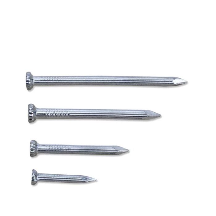 Four shiny silver steel nails with flat, ridged heads and pointed tips, lying diagonally on a white surface.