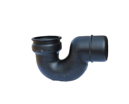 A black plastic waste gully trap on a white background. This plumbing fitting is designed to create a water seal, preventing unpleasant sewer gases from entering a building while allowing wastewater to pass through.